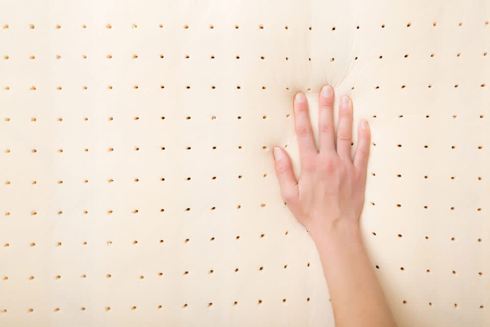 stock photo of a hand pressing memory foam