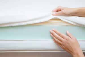 stock photo of a woman touching the different mattress layers