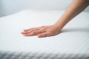stock photo of a hand testing memory foam mattress