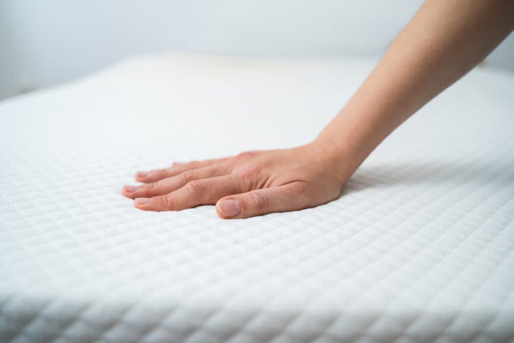 stock photo of a hand testing memory foam mattress