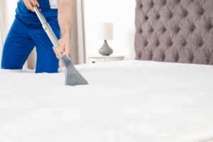 stock photo of a person cleaning a mattress