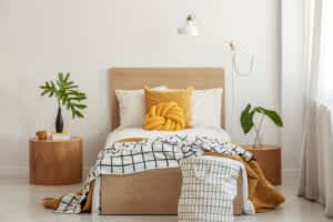 stock image of a single bed in a bedroom