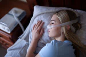 stock photo of a woman using a cpap machine