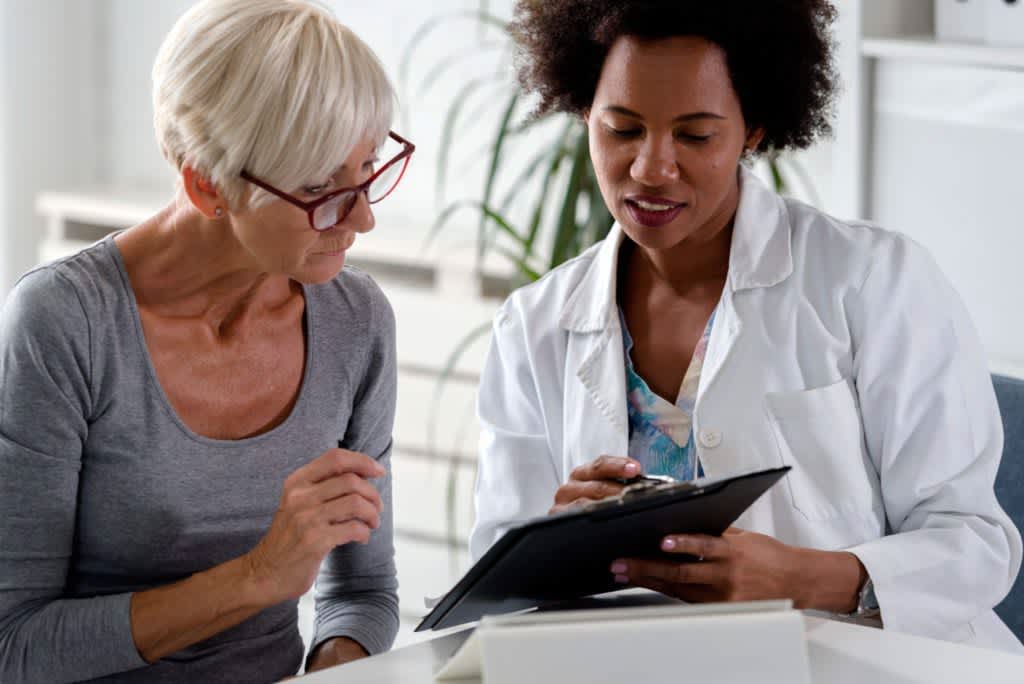stock photo of doctor talking to older patient