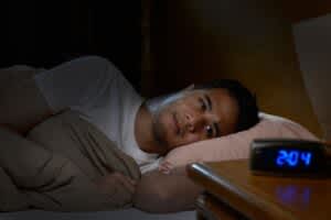 stock photo of a man experiencing insomnia