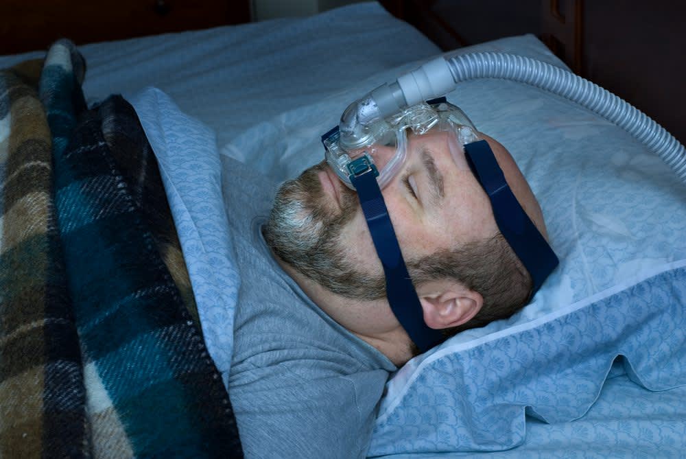 stock photo of a man using a cpap machine
