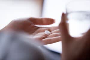 stock photo of a person taking a pill