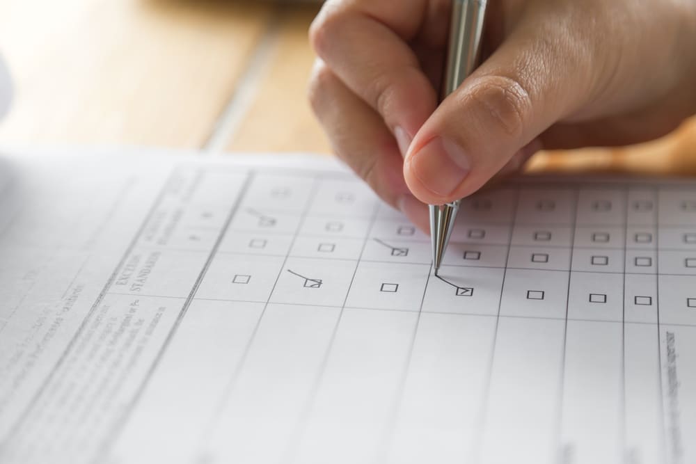 Closeup of a hand as someone fills out a questionnaire