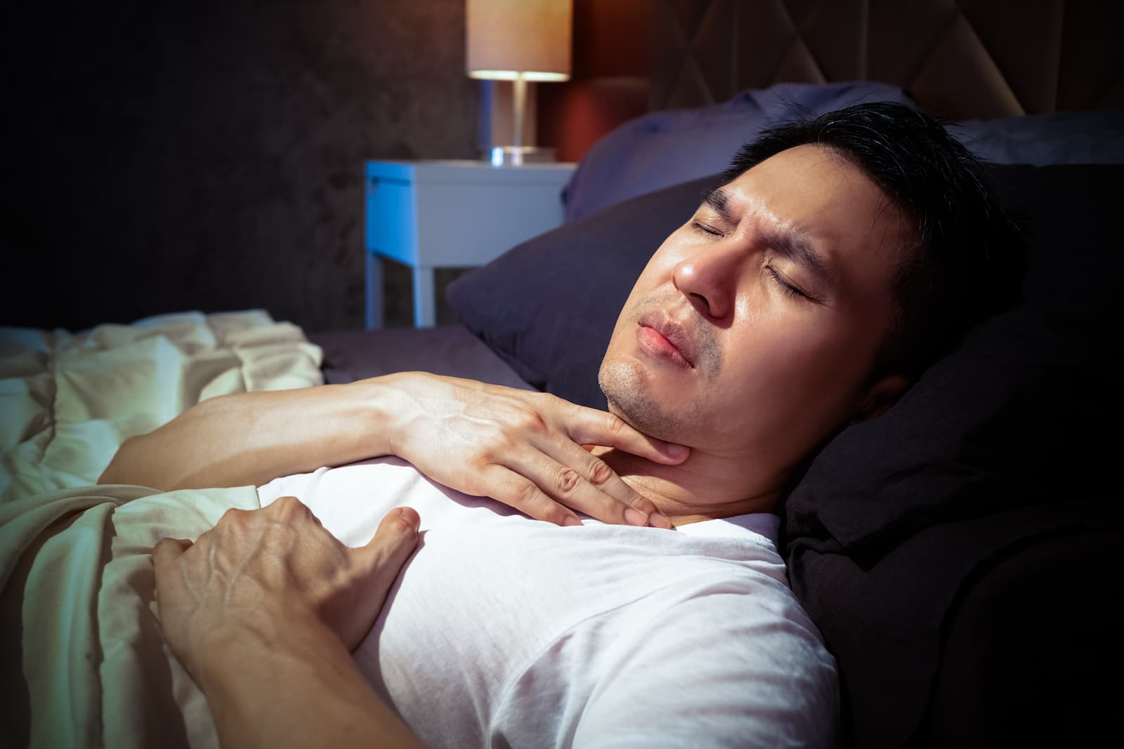 Man feeling shortness of breath while lying down